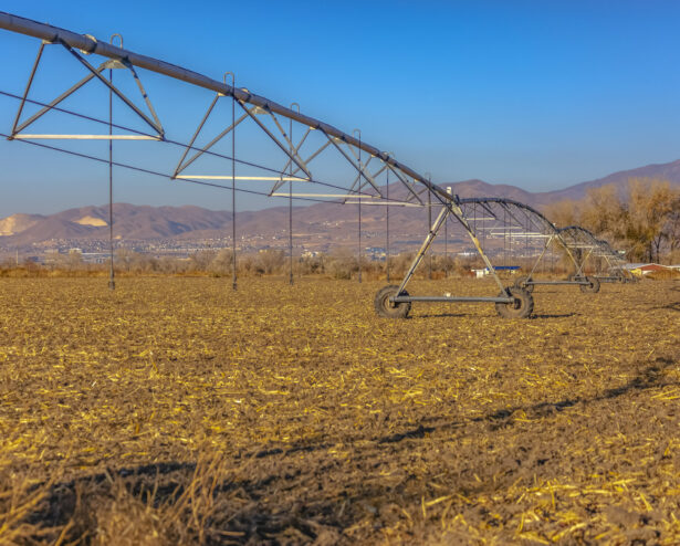 Wide angle view of center pivot irrigation system Wide angle view of center pivot irrigation system fall on an empty field in Utah Valley. This system irrigates and may spray fertilizer or pesticides on the plants when in season.