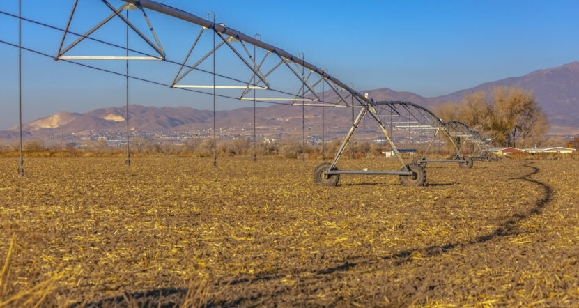 Wide angle view of center pivot irrigation system Wide angle view of center pivot irrigation system fall on an empty field in Utah Valley. This system irrigates and may spray fertilizer or pesticides on the plants when in season.